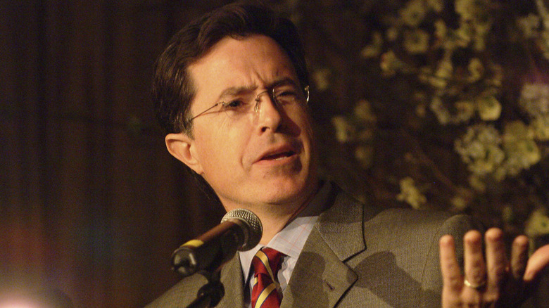 Closeup of Stephen Colbert speaking into microphone