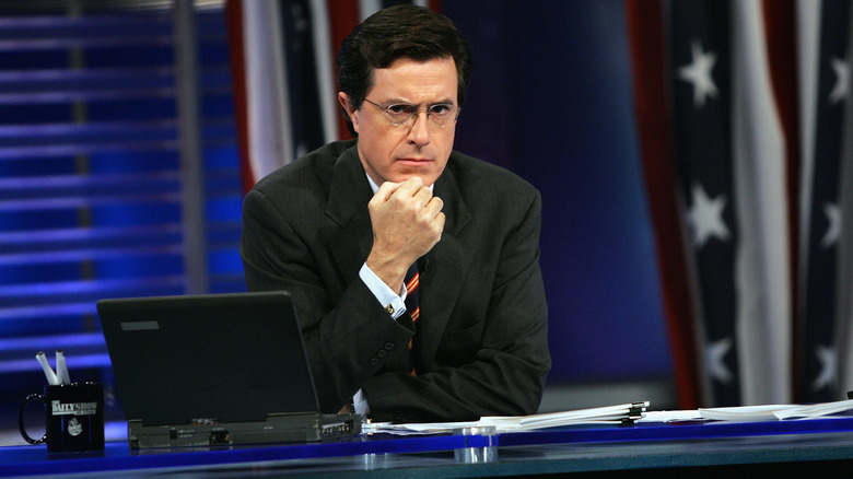 A young Stephen Colbert frowning on set of The Daily Show