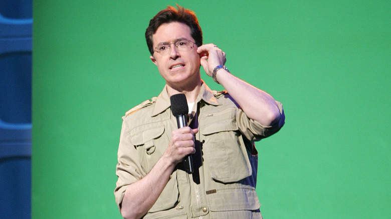 Closeup of a young Stephen Colbert performing on stage early in his career