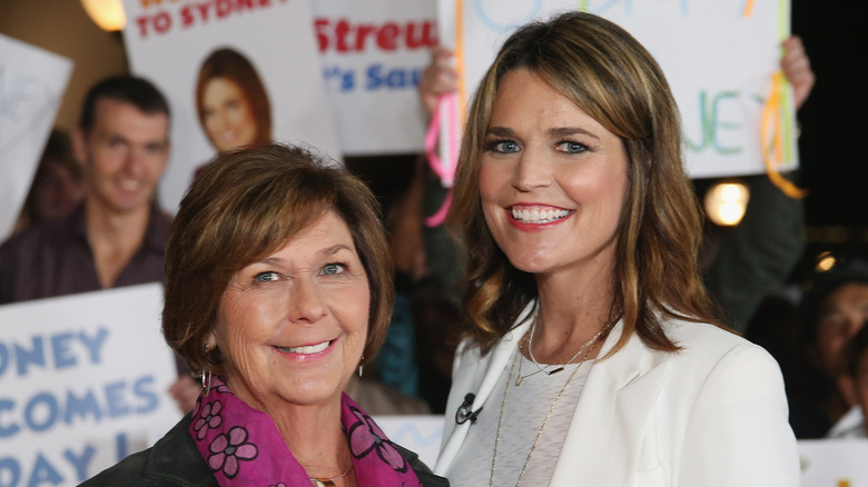Nancy Guthrie and Savannah Guthrie in front of people holding signs