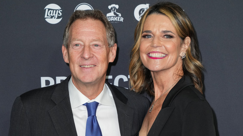 Savannah Guthrie in black and Michael Feldman wearing a suit