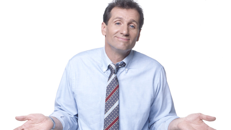 Ed O'Neill shrugging for Married with Children cast photo
