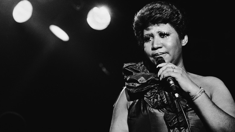 Aretha Franklin performs under stage lights
