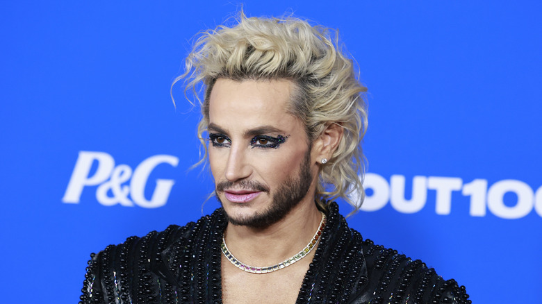 Frankie Grande with heavy black and blue eye makeup and a black blazer top.