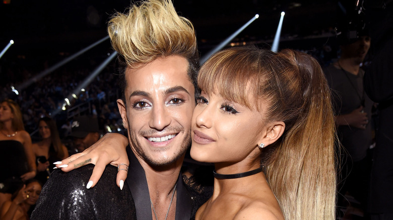 Frankie Grande posing with Ariana Grande who has her arm around her shoulders.