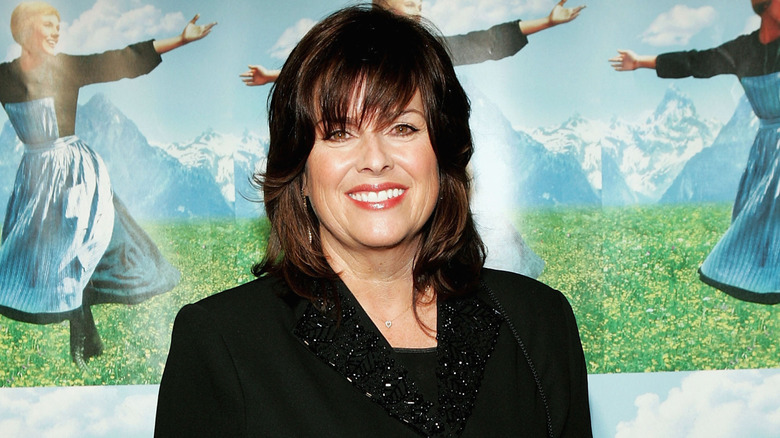 Debbie Turner smiling in front of 'Sound of Music' poster