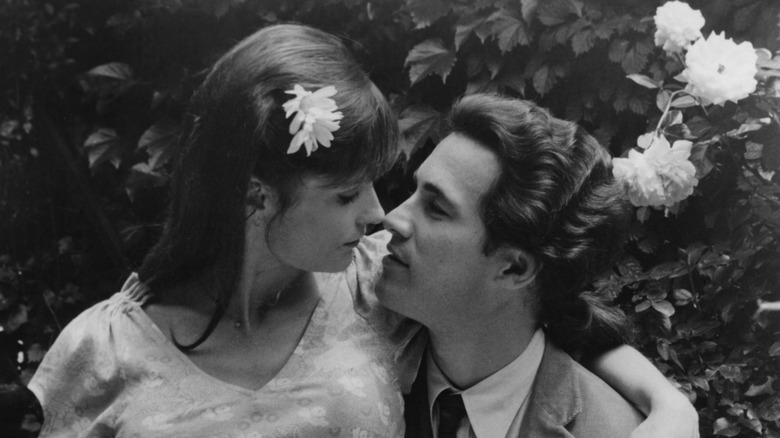 Margot Kidder sitting on Michael Ontkean lap in a scene from Willie & Phil.