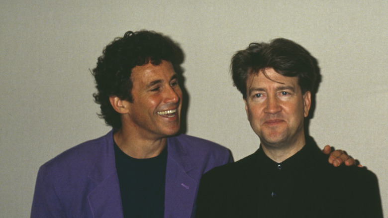 Michael Ontkean smiling at David Lynch and putting his hand on his shoulder.