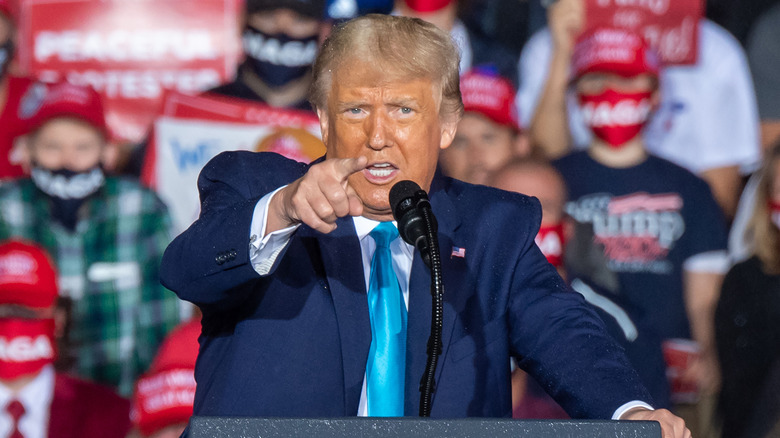Donald Trump pointing while giving speech as podium