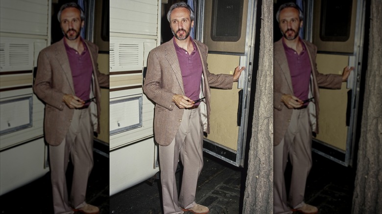 Michael Gross stands outside of a dressing room trailer on set