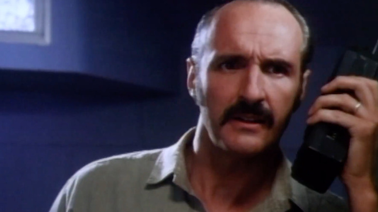 Actor Michael Gross holding a walkie talkie in "Tremors"