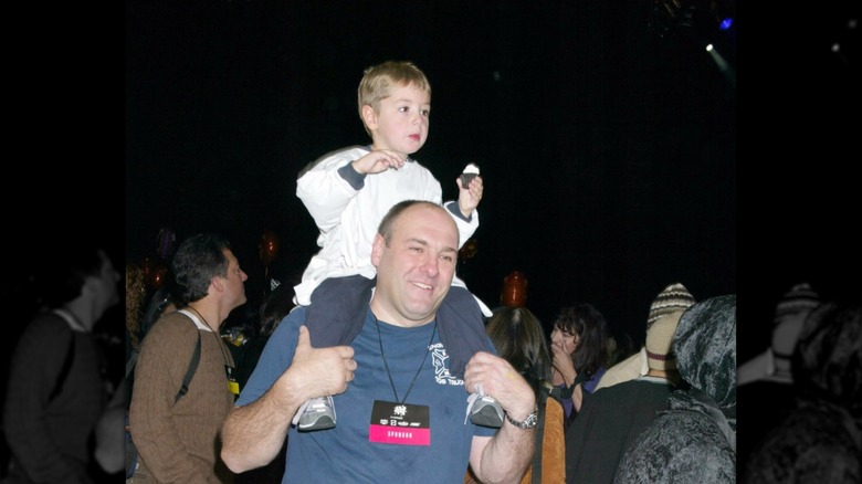 A young Michael Gandolfini being carried on James Gandolfini's shoulders at a charity event