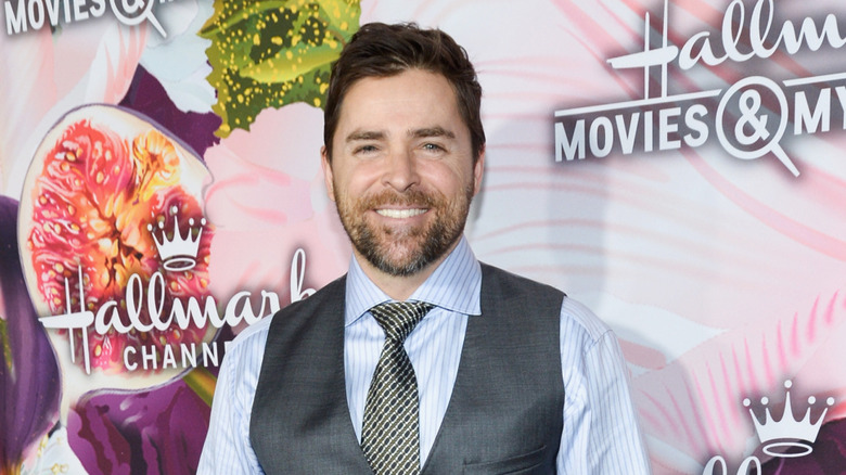 Kavan Smith smiling against a Hallmark backdrop.
