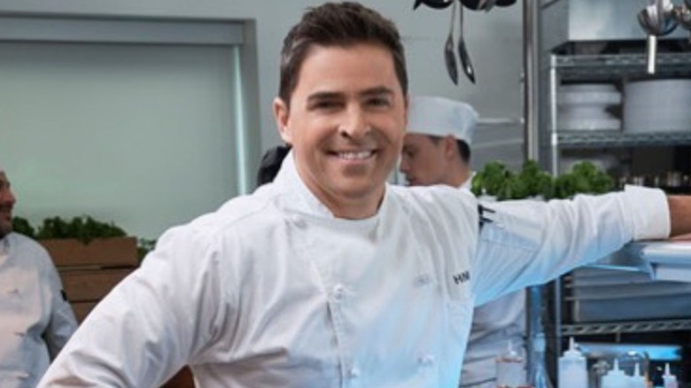 Kavan Smith smiling in a chef outfit.