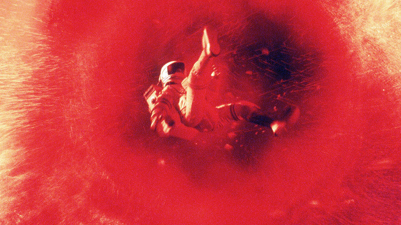 Kavan Smith floating through a bright red atmosphere in an astronaut suit on Escape From Mars.