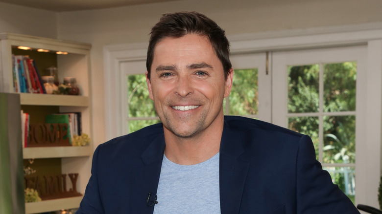 Kavan Smith smiling in a blue blazer.