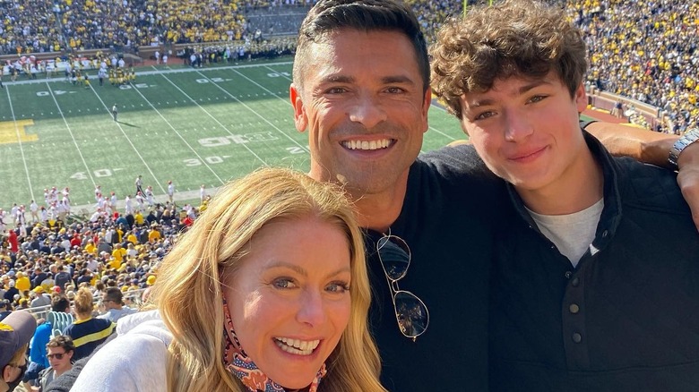 Kelly Ripa and Mark Consuelos' youngest child Joaquin Consuelos smiling at a Michigan football game with his parents