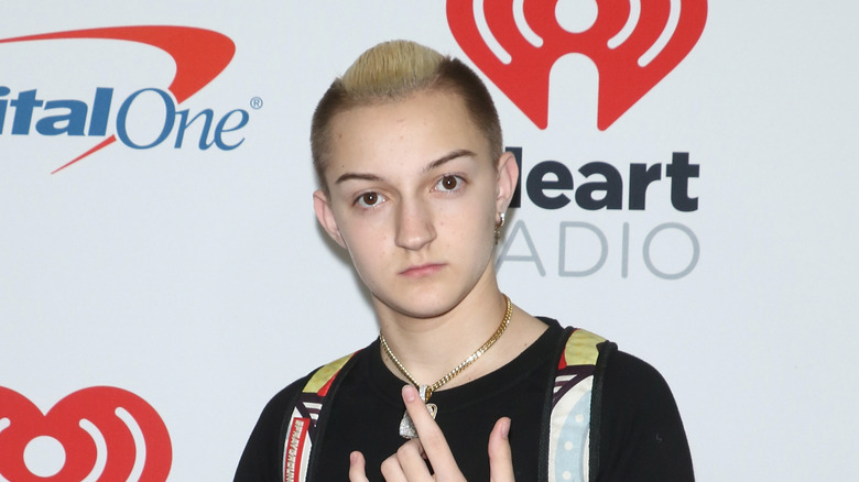 Russell Horning wearing a backpack and chain on the red carpet 2018