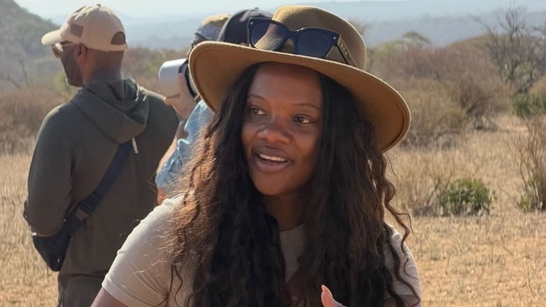 Zoe Jackson stands outside wearing a brown hat looking to the side