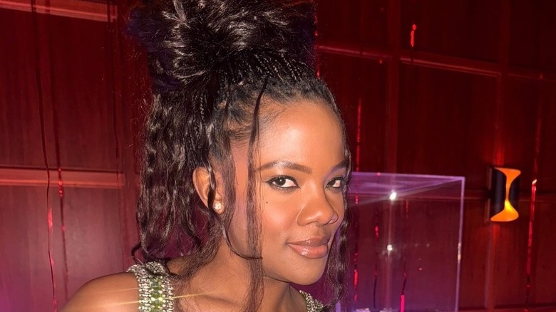 Zoe Jackson poses with her hair up wearing a sparkly green dress