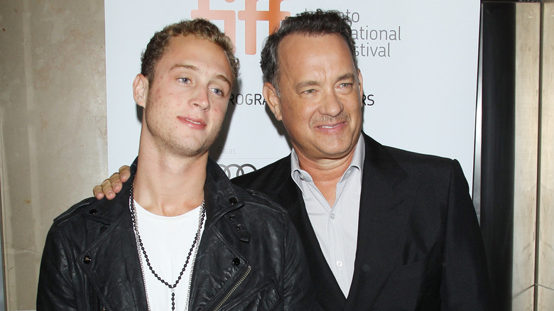 Chet Hanks smiling with father Tom Hanks at the Toronto International Film Festival