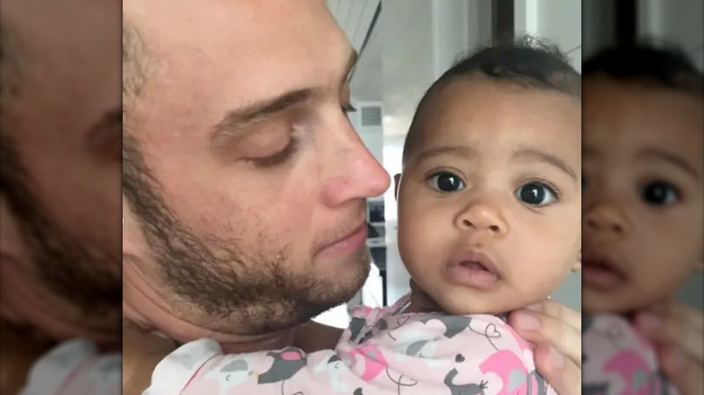 Chet Hanks holding his infant daughter