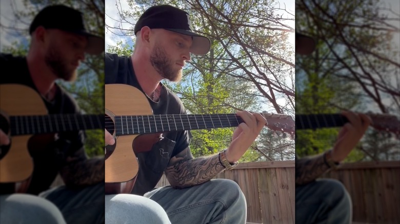 Chet Hanks playing a guitar