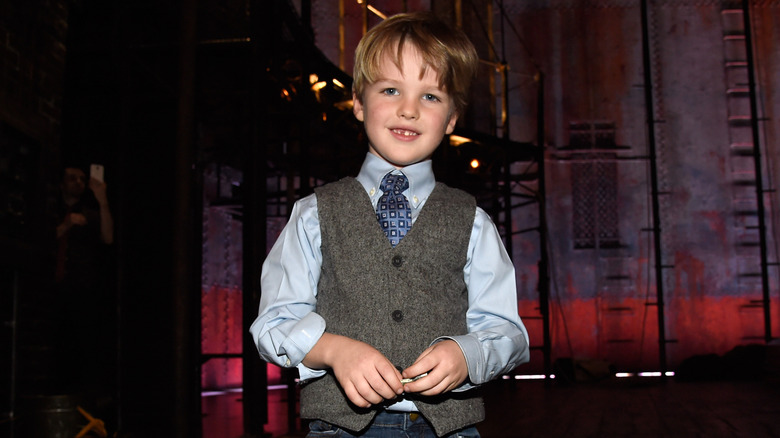Iain Armitage smiling backstage in a theater
