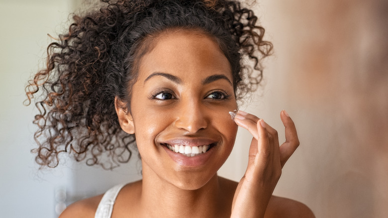 Woman applying skincare