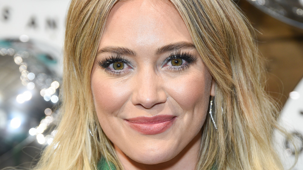Hilary Duff wearing green with her hair down