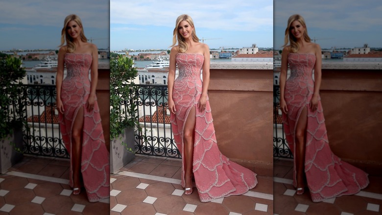 Ivanka Trump posing in a pink dress on a balcony