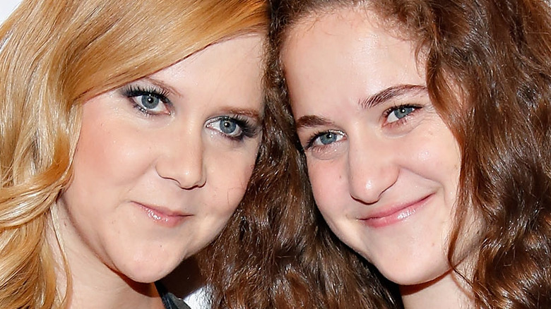 Sisters Amy Schumer and Kim Caramele posed with heads together