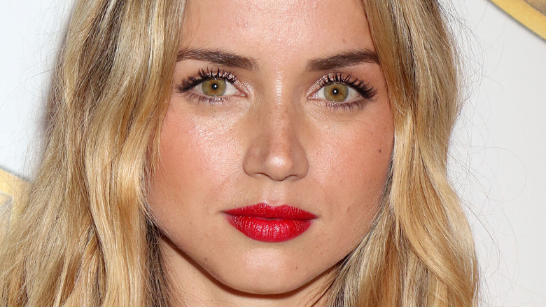 Ana de Armas poses with red lipstick