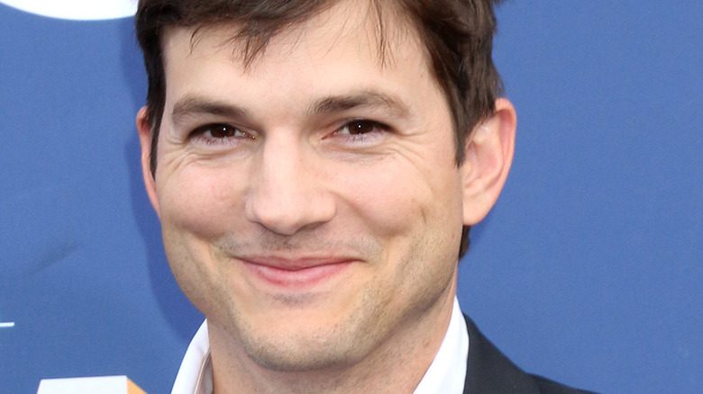 Ashton Kutcher smiling with mouth closed