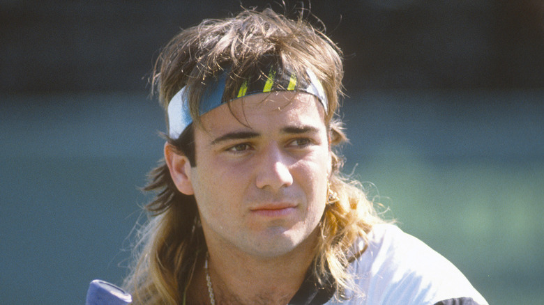 Young Andre Agassi on tennis court