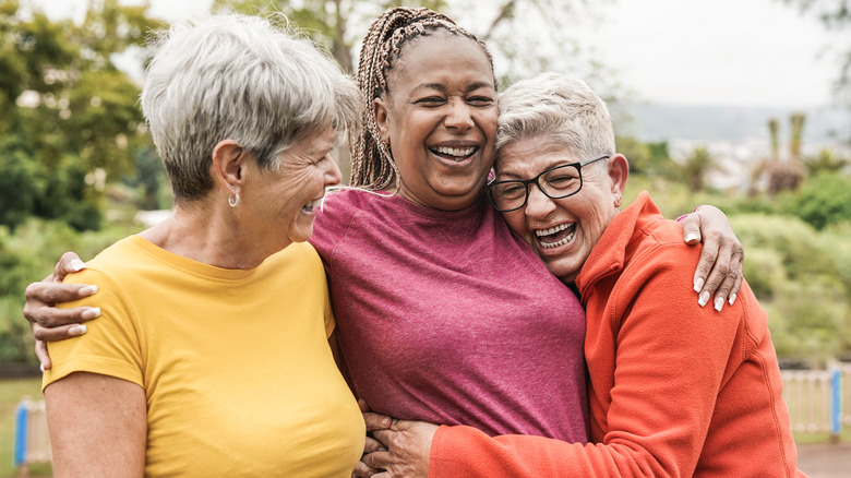 Three women embracing 