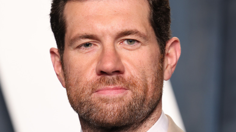 Billy Eichner poses on the red carpet in a suit