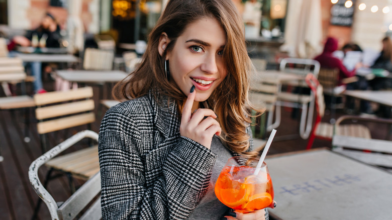 woman with blue eyes drinking