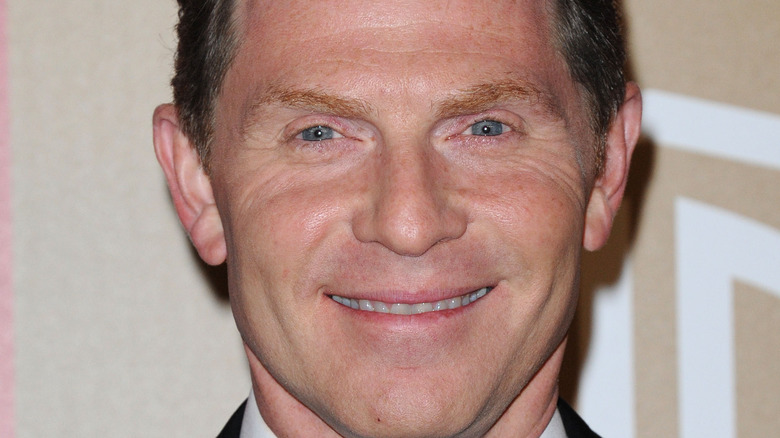 Bobby Flay smiling on red carpet