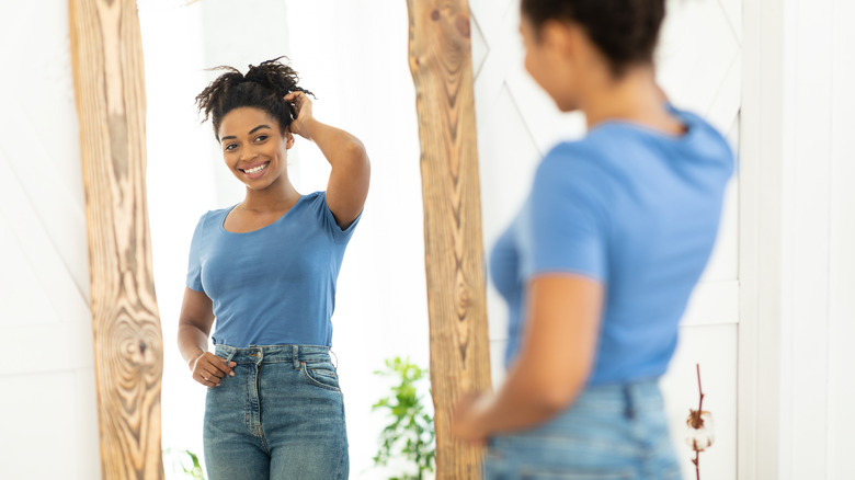 Woman smiling looking in mirror