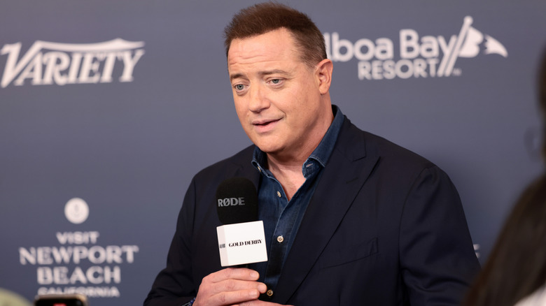 Brendon Fraser talking into a microphone