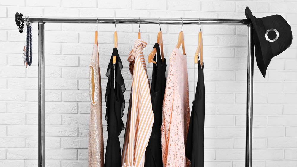 black and peach clothes on a clothing rack 