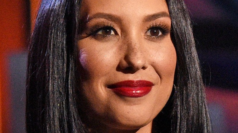 Cheryl Burke smiling at an event.