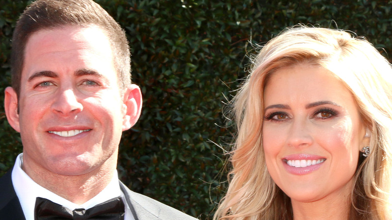 Christina Haack and Tarek El Moussa in front of greenery