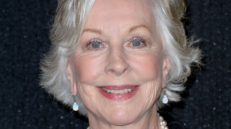 Christina Pickles smiling on red carpet