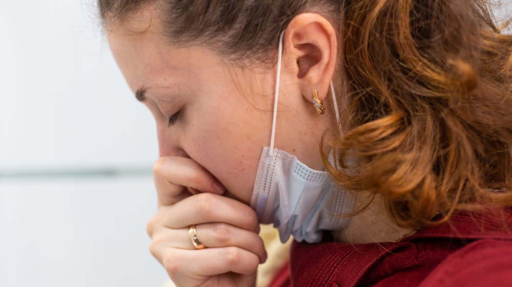 Sick woman with a mask under her chin