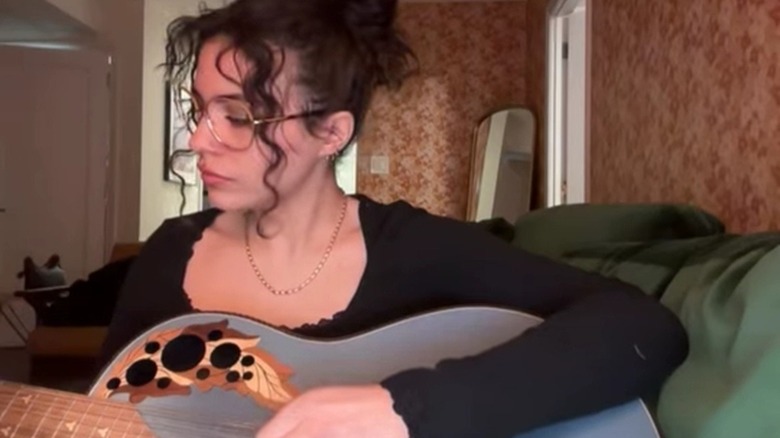 Lexi Jones plays a guitar and sings an original song.