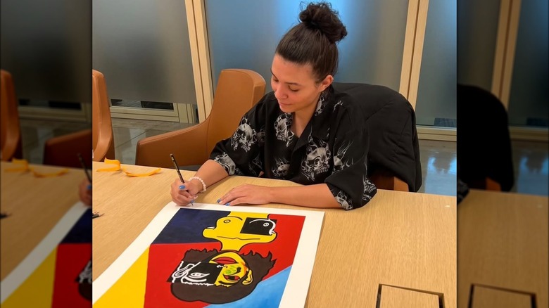 Lexi Jones signs one of her fine art prints