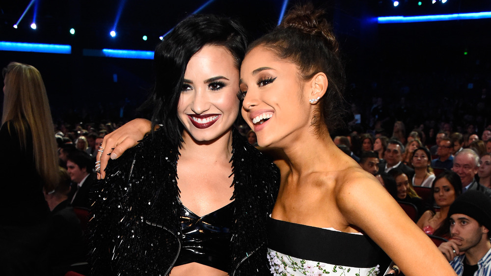Demi Lovato and Ariana Grande smiling