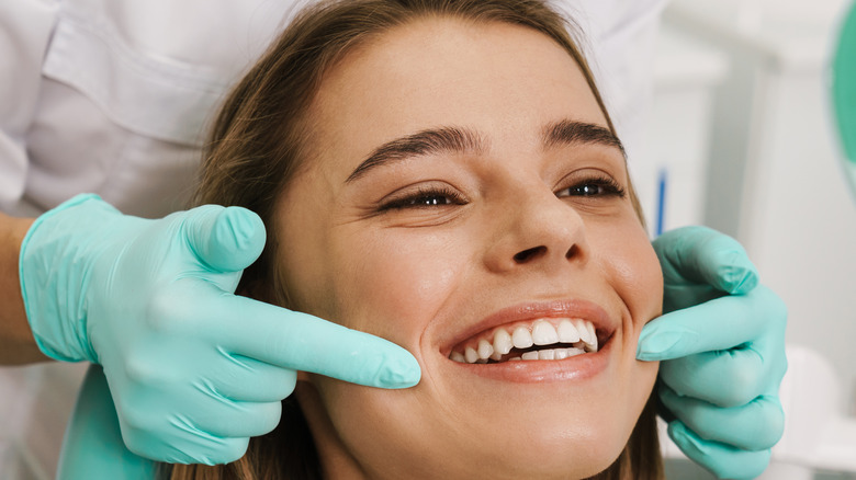 person smiling at the dentist